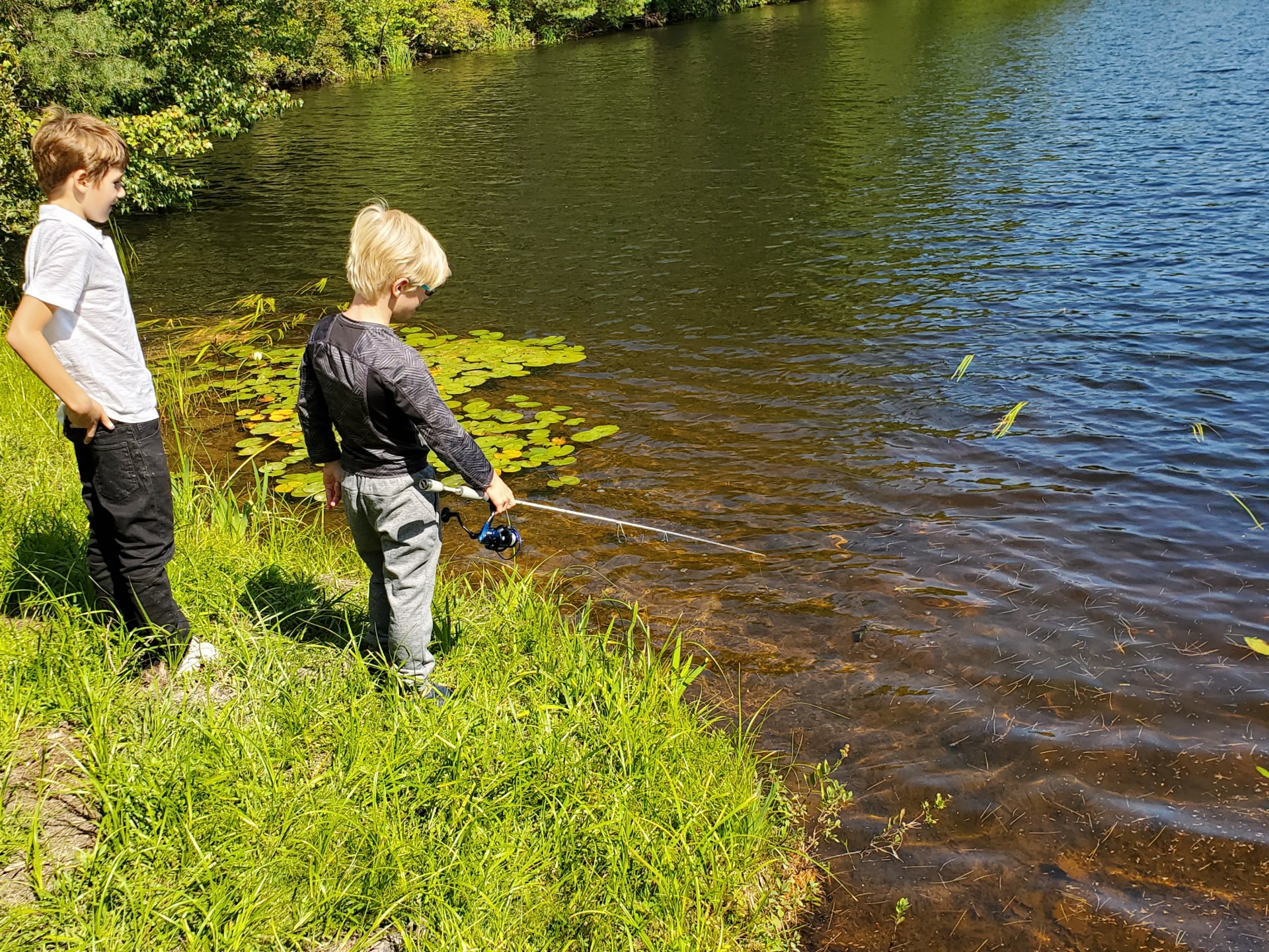 students fishing at pond