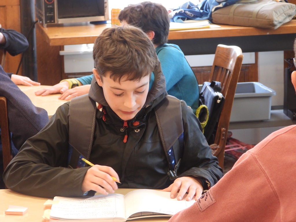 student in class working at desk - residential boarding schools - middle schools for students with learning disabilities near me – Hampshire Country School