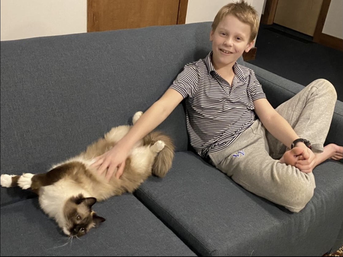 student with pet dog in dorm